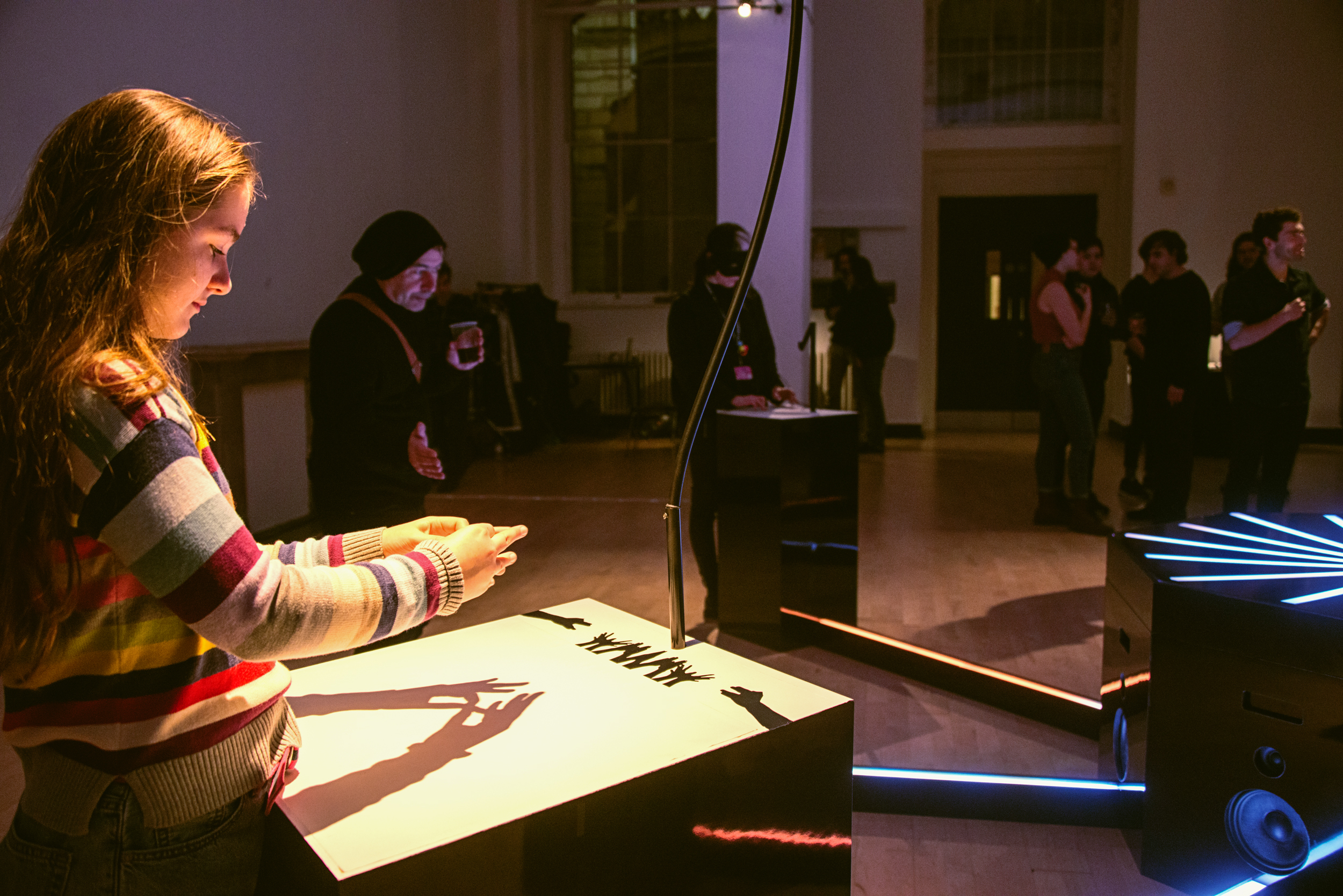 A child participant creates music by casting shadows with her hands using the Cave of Sounds instrument The Animal Kingdom, at Music Hackspace, Somerset House Studios, Jan 2018. Photo: Suzi Corker
