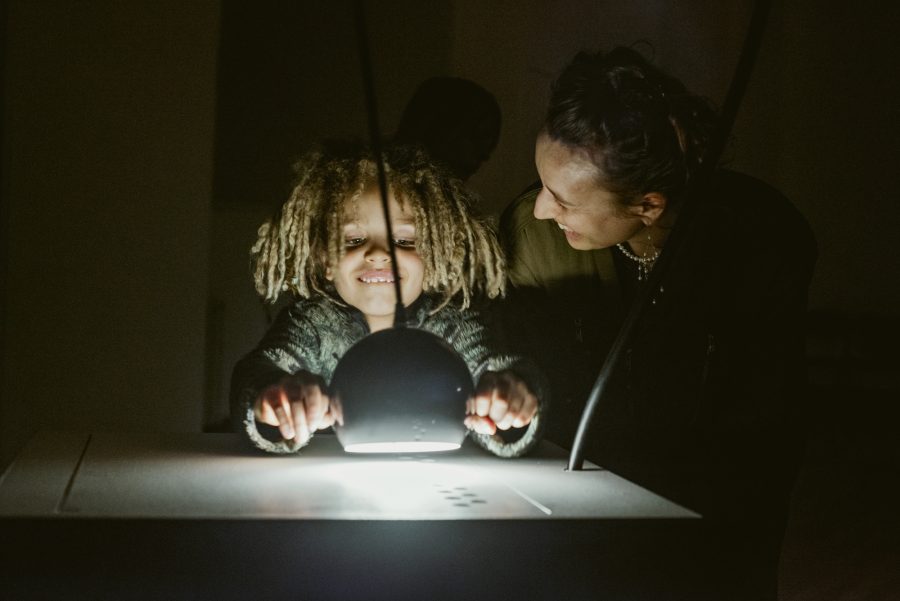 A child participates with Cave of Sounds, creating music by shining a light. Photo by Suzi Corker taken at Music Hackspace, Somerset House Studios, Jan 2018